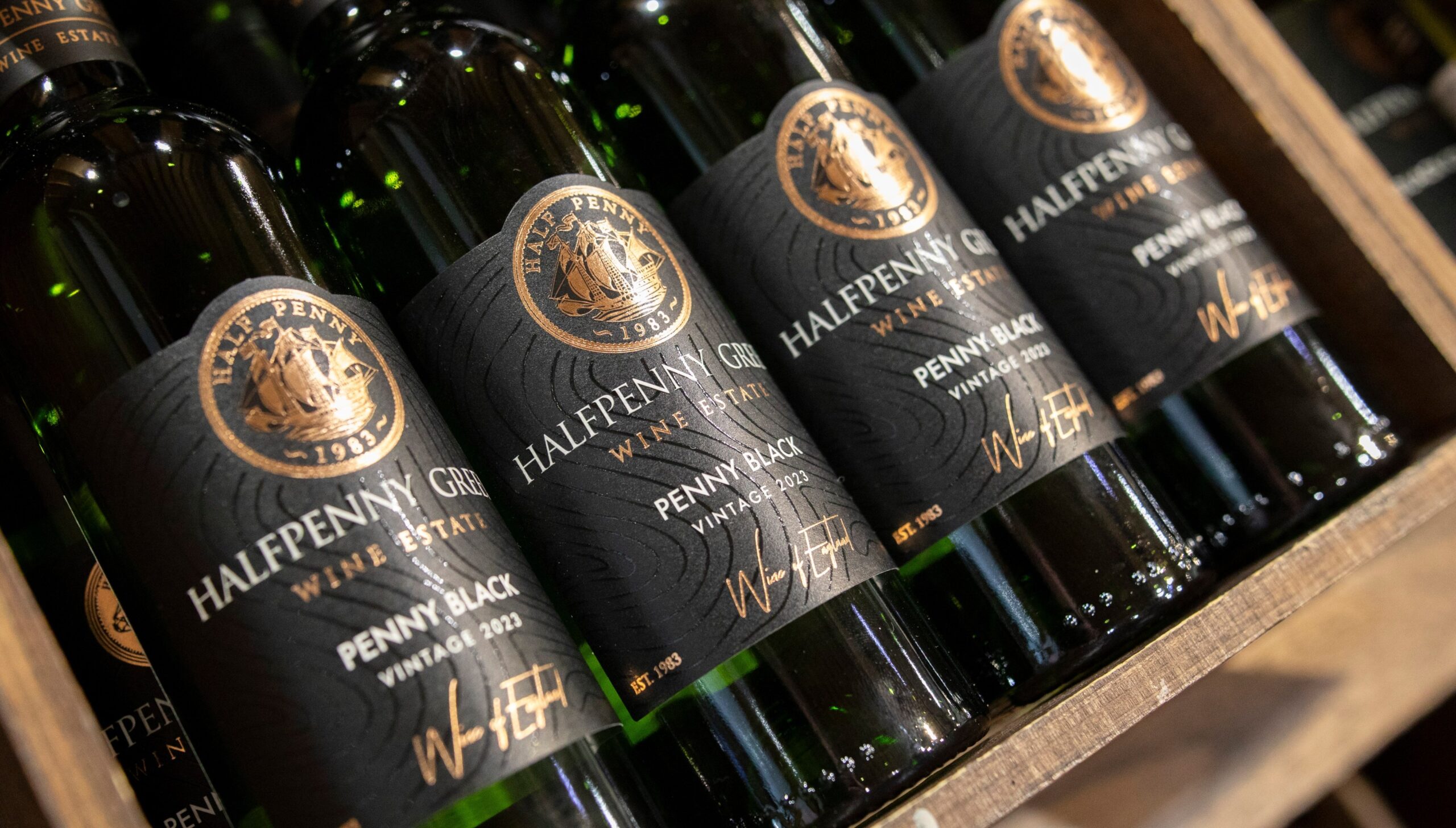 Bottles of white wine for sale in the shop at Halfpenny Green vineyard in Staffordshire